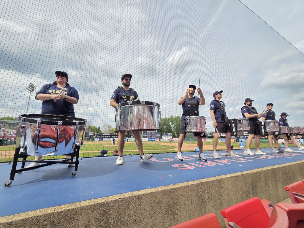 Kane County Clash Drumline performing on the dugout at Northwestern Medicine Field before a Kane County Cougars game, May 2026